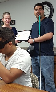 Receiving Blind Training Certificate from the director of the blind center.