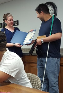 Receiving Certified Vocational Rehabilitation Counselor for the Blind Certificate from the director of the blind center.