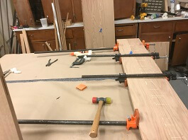 Michael's toy box panel being glued.