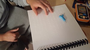 Miguel reading braille